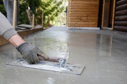 Mason,Leveling,And,Screeding,Concrete,Floor,Base,With,Square,Trowel