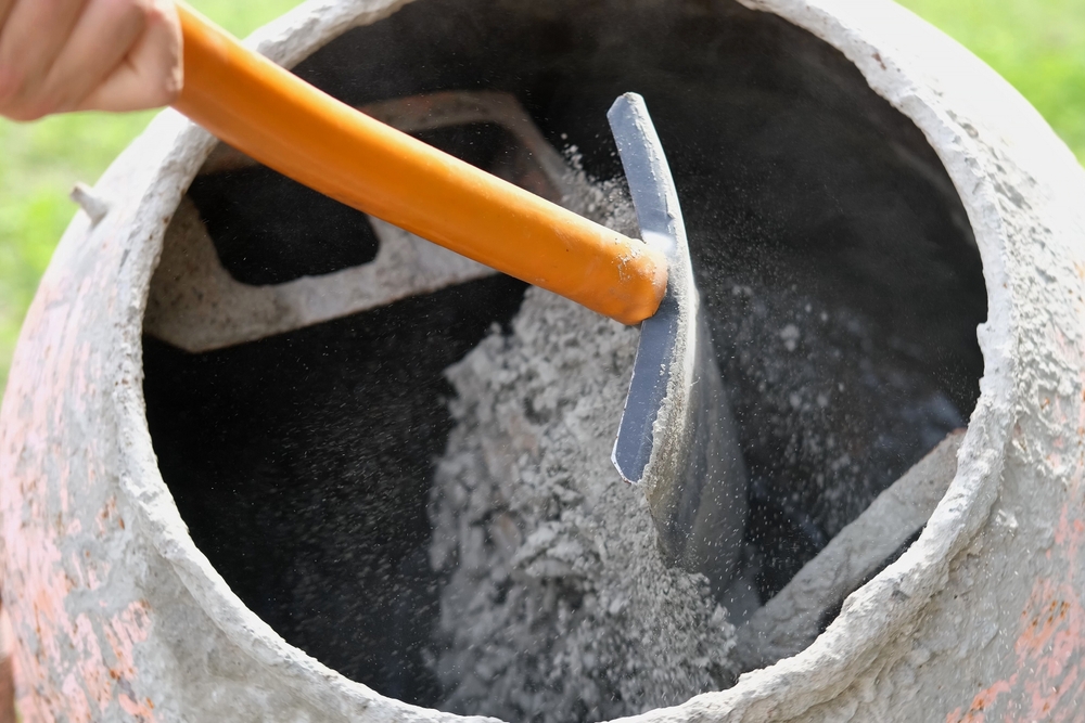 Construction,Site.,Adding,Lime,,Sand,And,Stones,To,Rotating,Cement