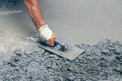 Hand,Builder,With,Trowel,Leveling,Concrete,,Spreading,Poured.,Some,Motion
