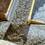 Workers,Are,Pouring,Cement,On,Side,Of,House,In,Order