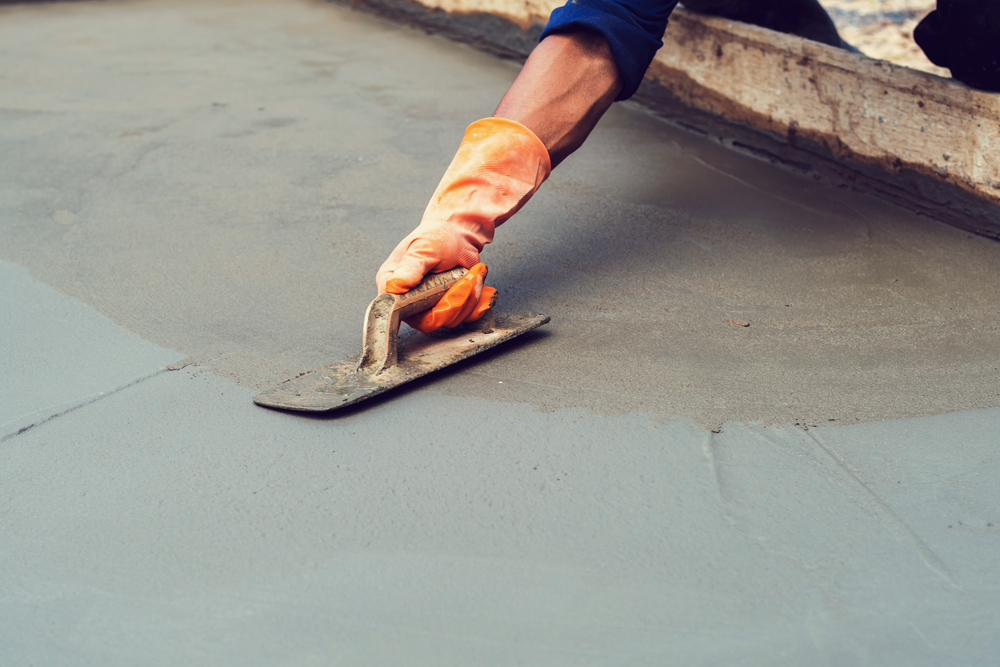 Worker,Leveling,Concrete,Pavement,For,Mix,Cement,At,Construction,Site